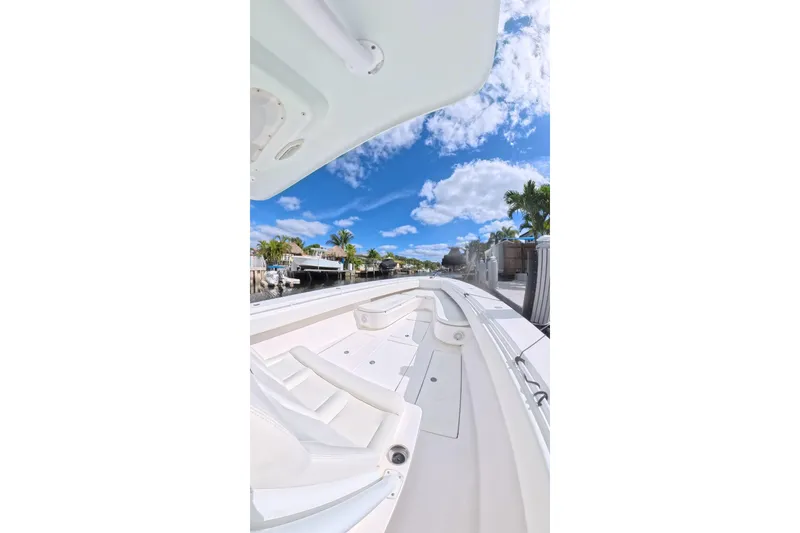 Slide: The Image of 2010 SeaHunter 40 boat deck under clear blue sky with palm trees. - 5