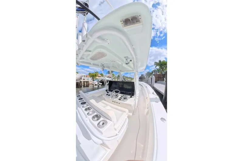 Slide: The Image of 2010 SeaHunter 40 boat interior with steering console, cup holders, and clear sky background. - 8