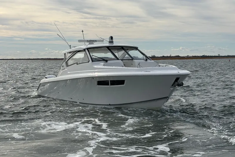 The Image of 2022 Pursuit DC 365 Dual Console boat cruising on open water. - 0