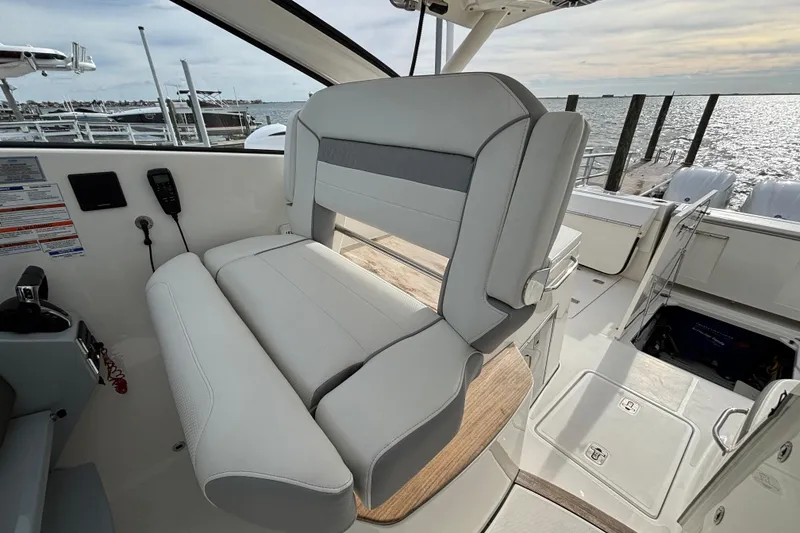 Slide: The Image of 2022 Pursuit DC 365 Dual Console boat interior with luxurious seating and ocean view. - 20