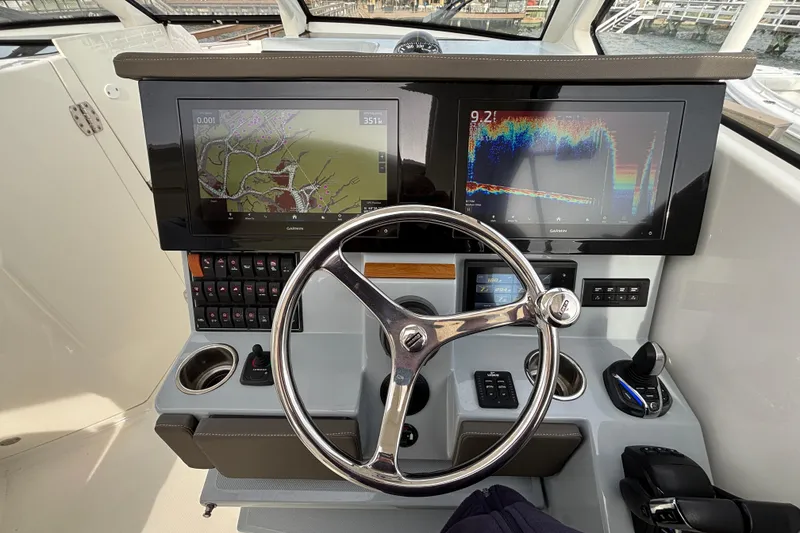 Slide: The Image of 2022 Pursuit DC 365 Dual Console helm with dual Garmin displays and steering wheel. - 21