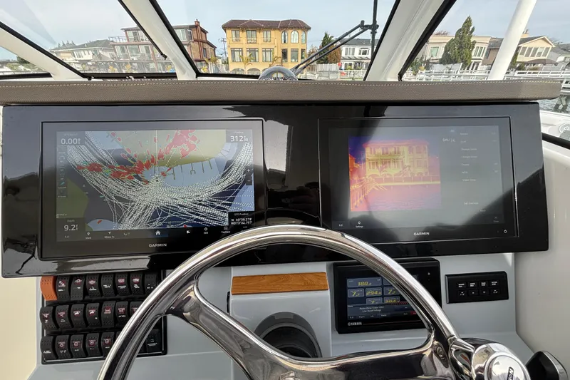 Slide: The Image of 2022 Pursuit DC 365 Dual Console helm with Garmin navigation displays and steering wheel. - 22