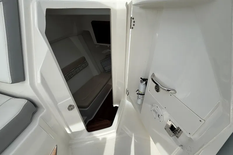 Slide: The Image of 2022 Pursuit DC 365 Dual Console cabin interior with seating and storage. - 31