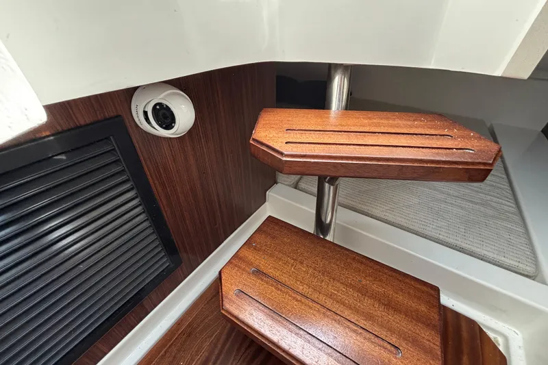 Slide: The Image of Interior of 2022 Pursuit DC 365 Dual Console with wooden steps and security camera. - 32