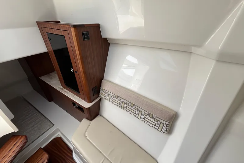 Slide: The Image of 2022 Pursuit DC 365 Dual Console interior with wood cabinetry and cushioned seating. - 37