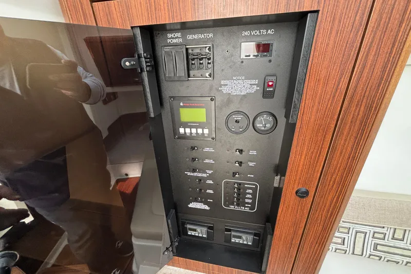 Slide: The Image of Electrical control panel on a 2022 Pursuit DC 365 Dual Console boat. - 38