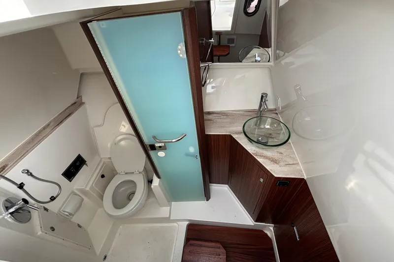 Slide: The Image of 2022 Pursuit DC 365 Dual Console bathroom with modern fixtures and glass sink. - 42