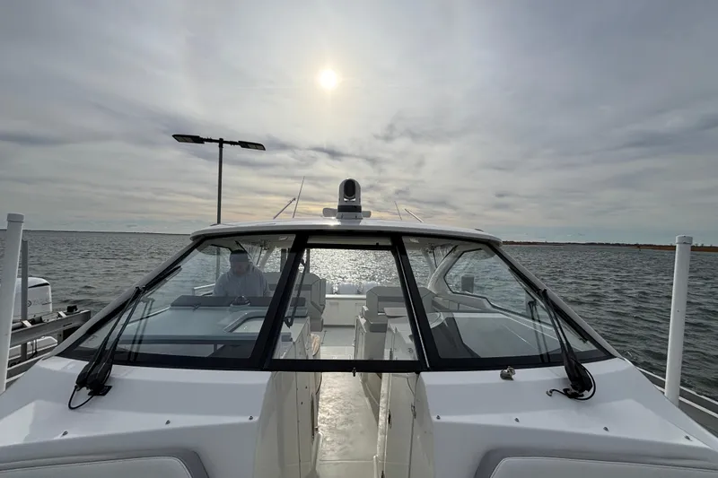 Slide: The Image of 2022 Pursuit DC 365 Dual Console boat on water under cloudy sky. - 44