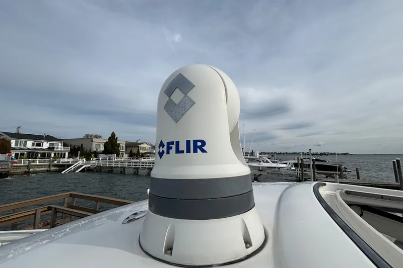 Slide: The Image of FLIR camera on 2022 Pursuit DC 365 Dual Console boat, docked by waterfront homes. - 45