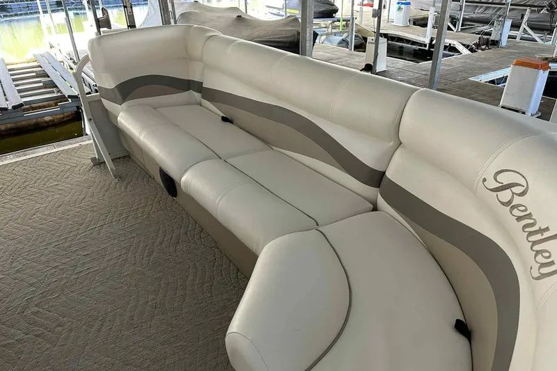 Slide: The Image of 2011 Bentley Pontoons 240/243 Cruise with beige seating on a docked pontoon boat. - 12