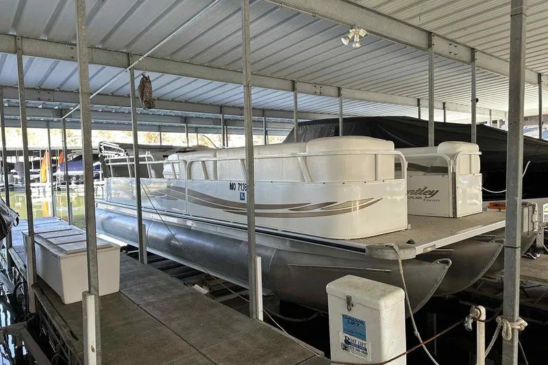 Slide: The Image of 2011 Bentley Pontoons 240/243 Cruise docked in a covered marina. - 13