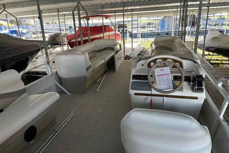 Slide: The Image of 2011 Bentley Pontoons 240/243 Cruise interior with seating and steering console. - 18