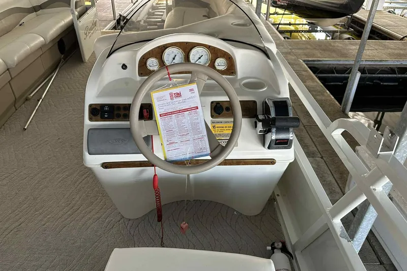Slide: The Image of 2011 Bentley Pontoons 240/243 Cruise dashboard with steering wheel and controls. - 19