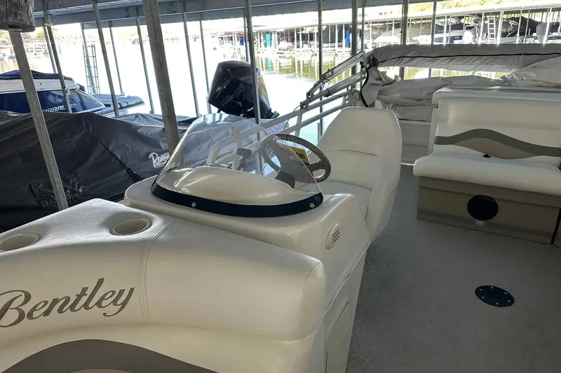 Slide: The Image of 2011 Bentley Pontoons 240/243 Cruise interior with steering console and seating. - 2