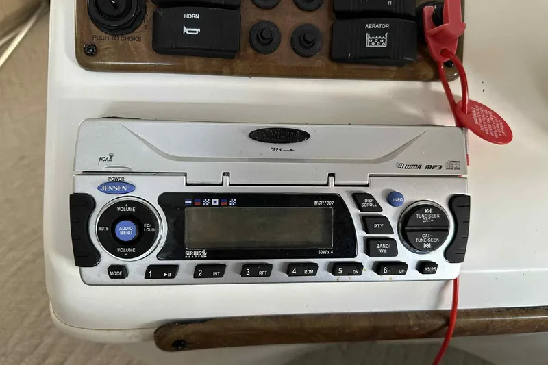 Slide: The Image of Jensen stereo system on 2011 Bentley Pontoons 240/243 Cruise dashboard with control panel. - 3