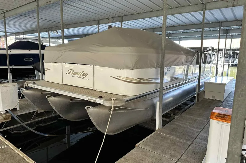 Slide: The Image of 2011 Bentley Pontoons 240/243 Cruise docked with cover in marina. - 7