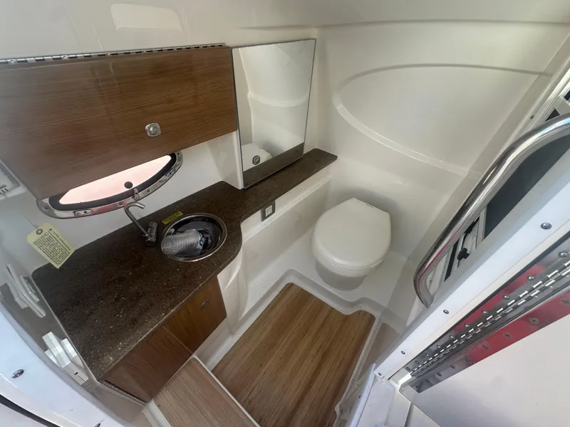 Slide: The Image of 2015 Formula 310 Bowrider bathroom with sink, toilet, and wood accents. - 16