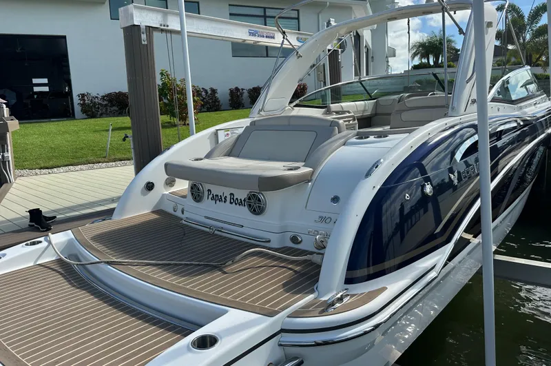 Slide: The Image of 2015 Formula 310 Bowrider boat docked, featuring spacious seating and sleek design. - 3