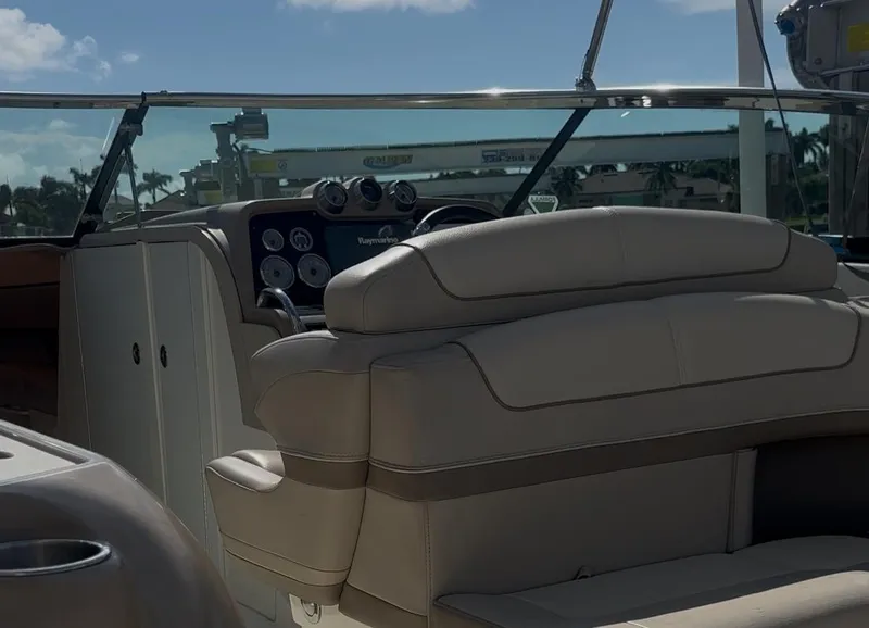 Slide: The Image of 2015 Formula 310 Bowrider interior with beige seating and dashboard view. - 9