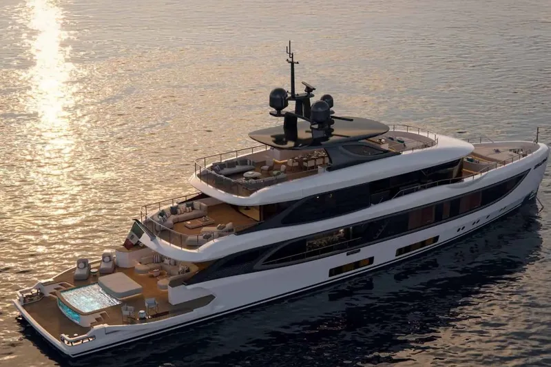 Slide: The Image of Luxurious 2028 Benetti Oasis 42M Co Ownership yacht on serene waters at sunset. - 1