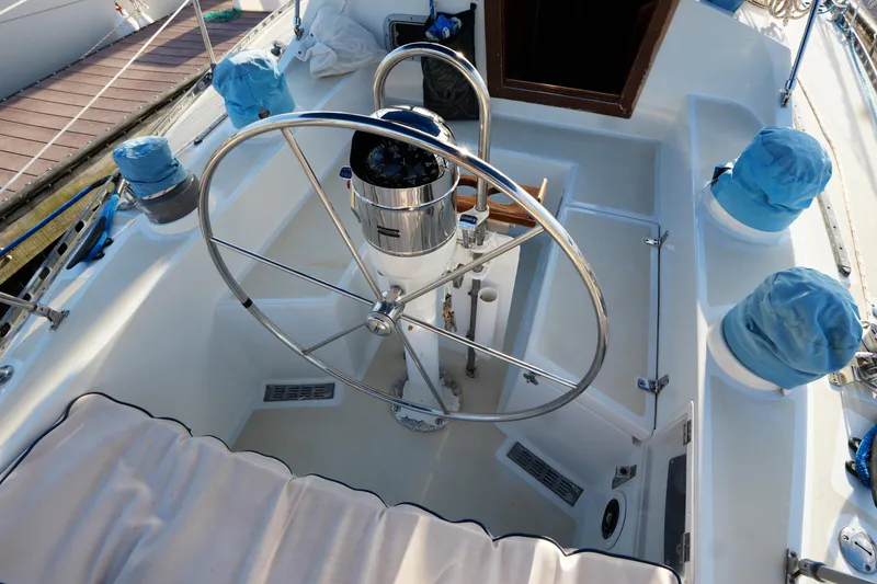 Slide: The Image of 1985 Ta Chiao 38 sailboat cockpit with steering wheel and covered winches. - 10