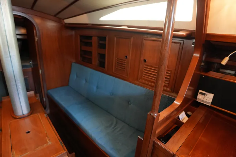Slide: The Image of Interior of 1985 Ta Chiao 38 sailboat with wooden cabinetry and blue cushioned seating. - 17