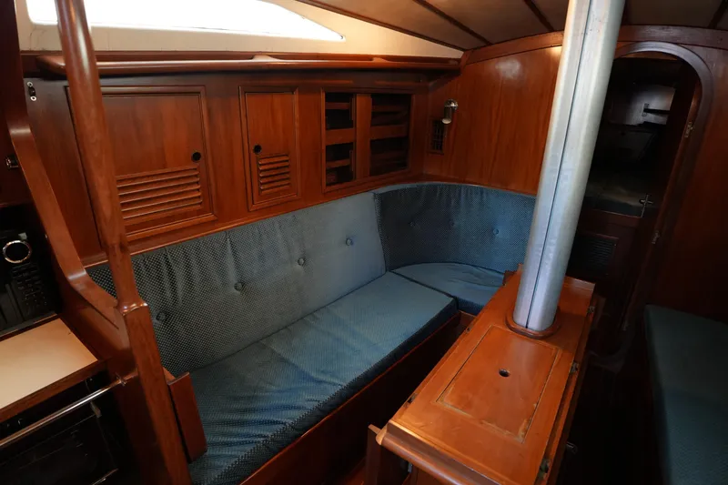 Slide: The Image of Interior of 1985 Ta Chiao 38 sailboat with wooden cabinetry and blue seating. - 18