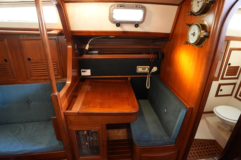 Slide: The Image of 1985 Ta Chiao 38 yacht interior with wooden table, seating, and nautical instruments. - 22