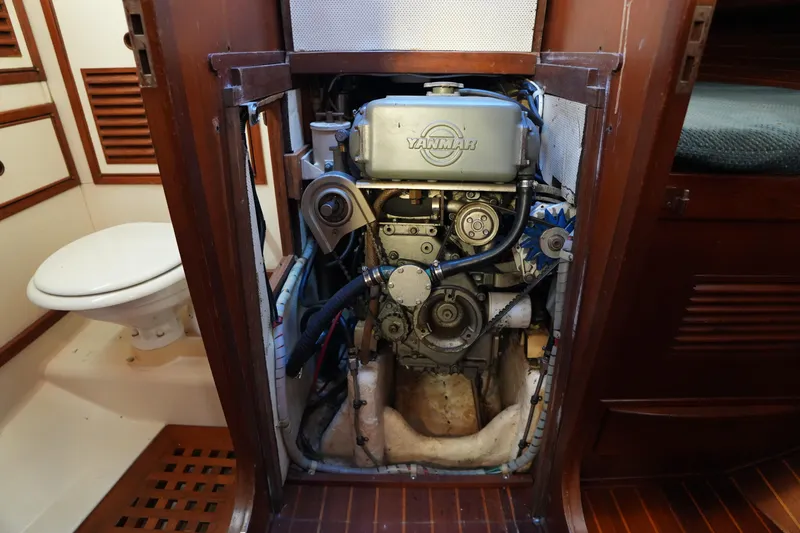 Slide: The Image of 1985 Ta Chiao 38 sailboat engine compartment with Yanmar engine, wooden interior. - 29