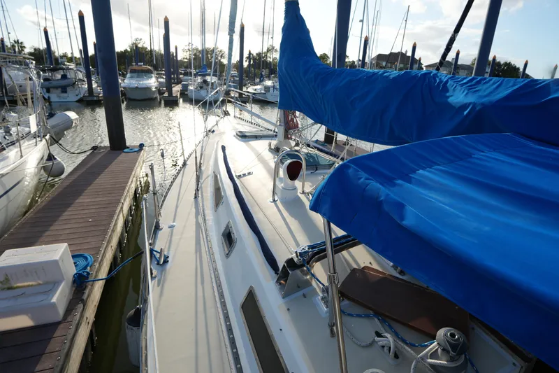 Slide: The Image of 1985 Ta Chiao 38 sailboat docked at marina with blue covers. - 8