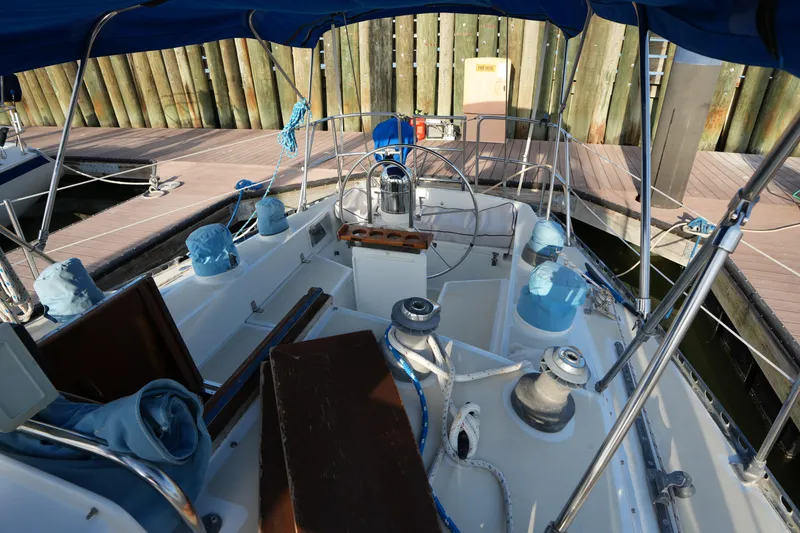 Slide: The Image of Cockpit of 1985 Ta Chiao 38 sailboat with blue covers and wooden accents at dock. - 9