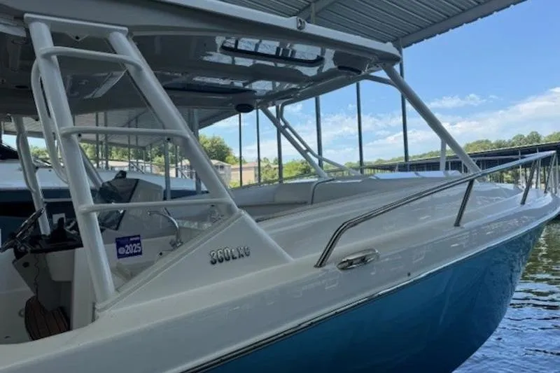 Slide: The Image of 2016 Everglades 360LXC boat docked under a covered marina. - 10
