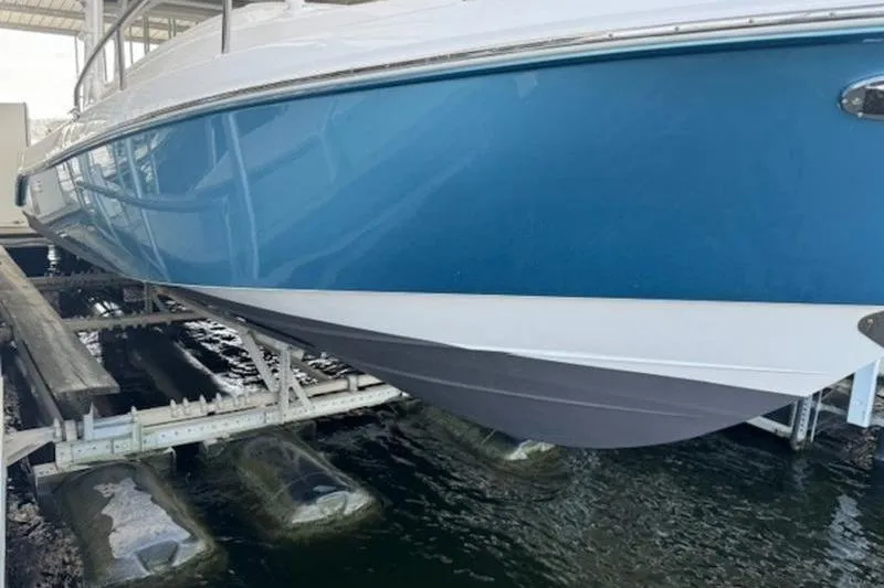 Slide: The Image of 2016 Everglades 360LXC boat on lift, blue hull, docked. - 29