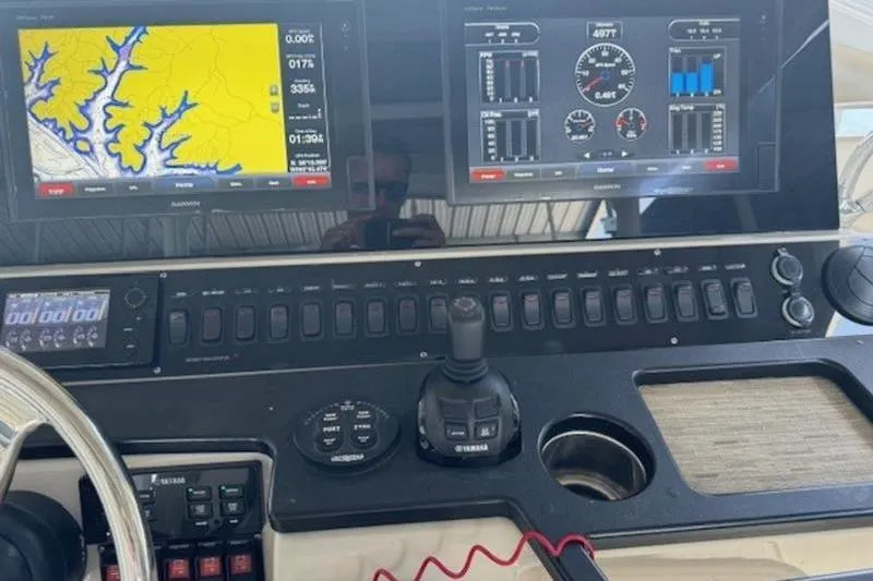 Slide: The Image of Control panel of a 2016 Everglades 360LXC boat with navigation screens and controls. - 31