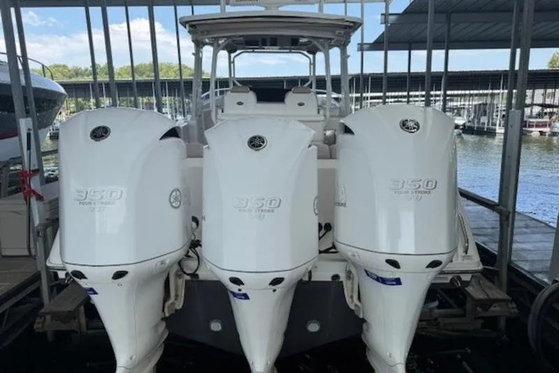 Slide: The Image of 2016 Everglades 360LXC boat with triple 350 horsepower engines docked in marina. - 34