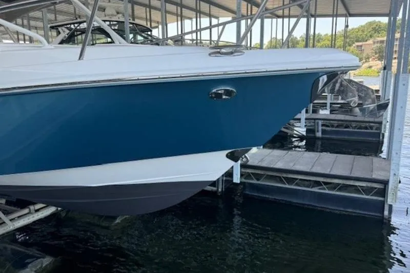 Slide: The Image of 2016 Everglades 360LXC boat docked in a marina, blue hull visible. - 35