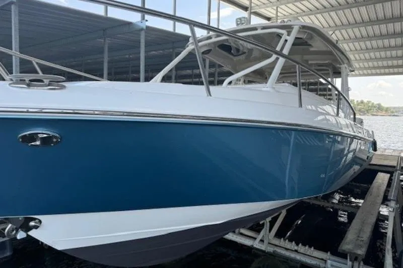 Slide: The Image of 2016 Everglades 360LXC boat docked under a covered marina. - 36