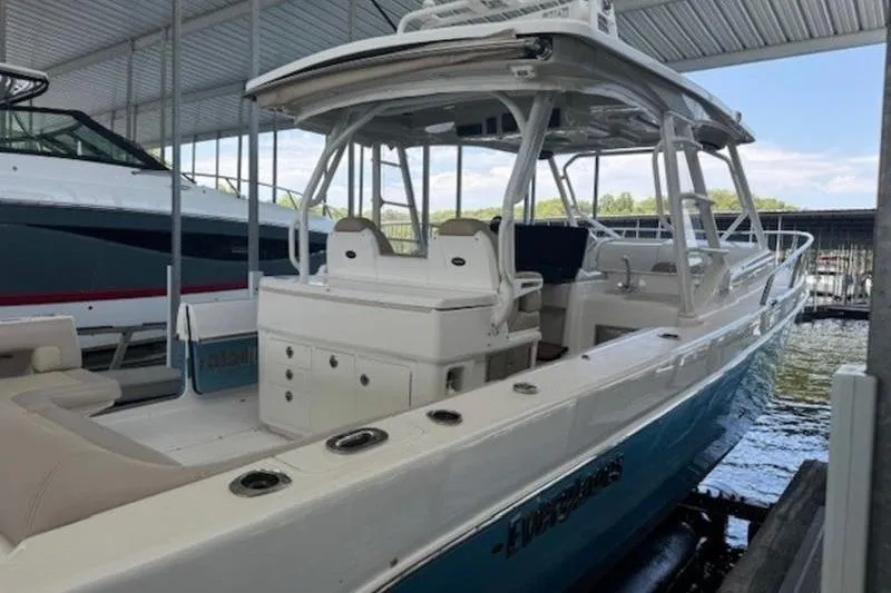 Slide: The Image of 2016 Everglades 360LXC boat docked under a covered marina. - 38