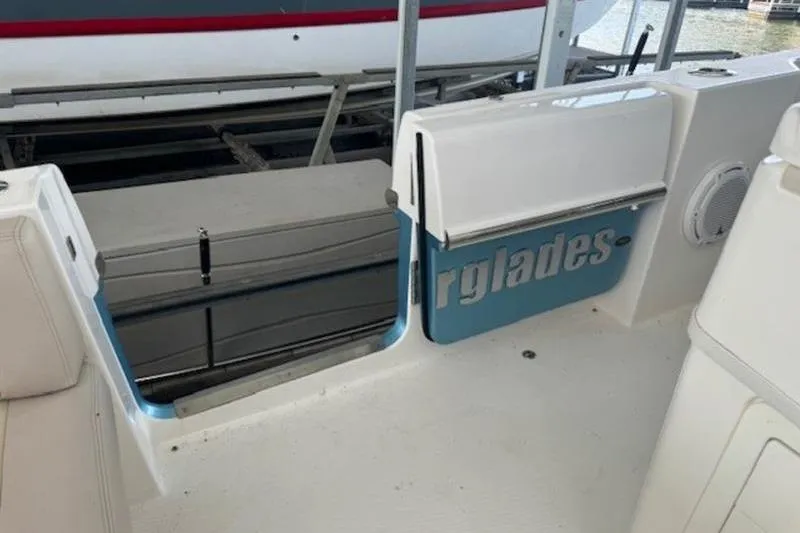 Slide: The Image of 2016 Everglades 360LXC boat interior with open side door and visible branding. - 42