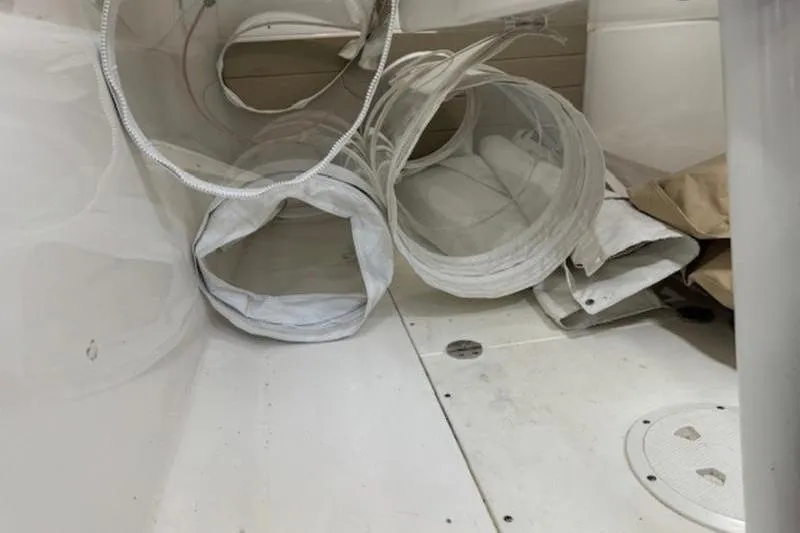 Slide: The Image of Interior view of a 2016 Everglades 360LXC boat with coiled white hoses. - 43