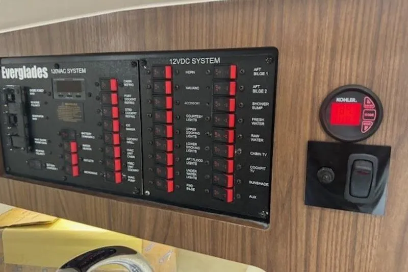 Slide: The Image of Control panel of a 2016 Everglades 360LXC boat with 12VDC and 120VAC systems. - 44