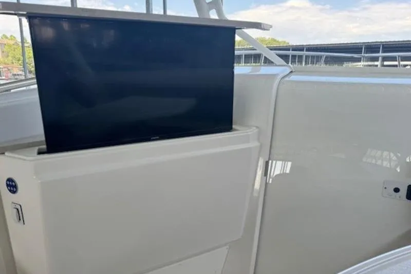 Slide: The Image of 2016 Everglades 360LXC boat with a retractable TV screen on deck. - 47