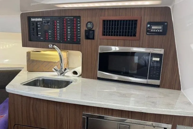 Slide: The Image of Interior of 2016 Everglades 360LXC boat with sink, microwave, and control panel. - 51