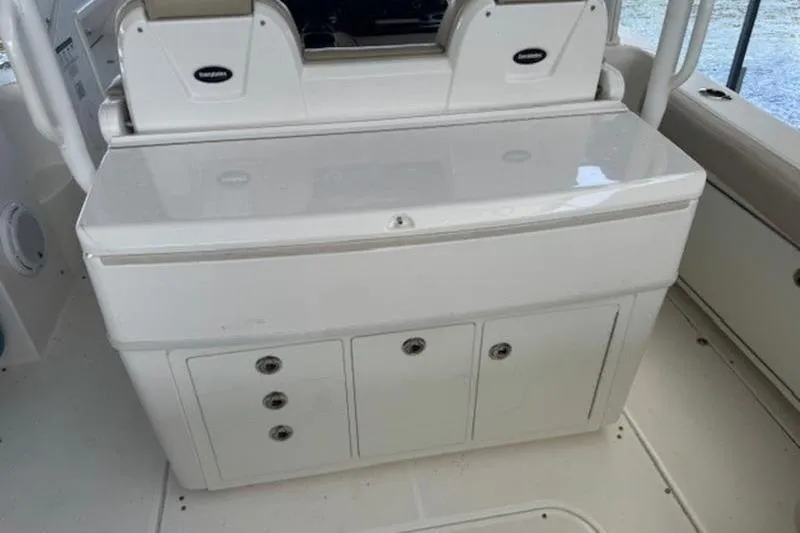 Slide: The Image of 2016 Everglades 360LXC boat interior with storage compartments and seating. - 9