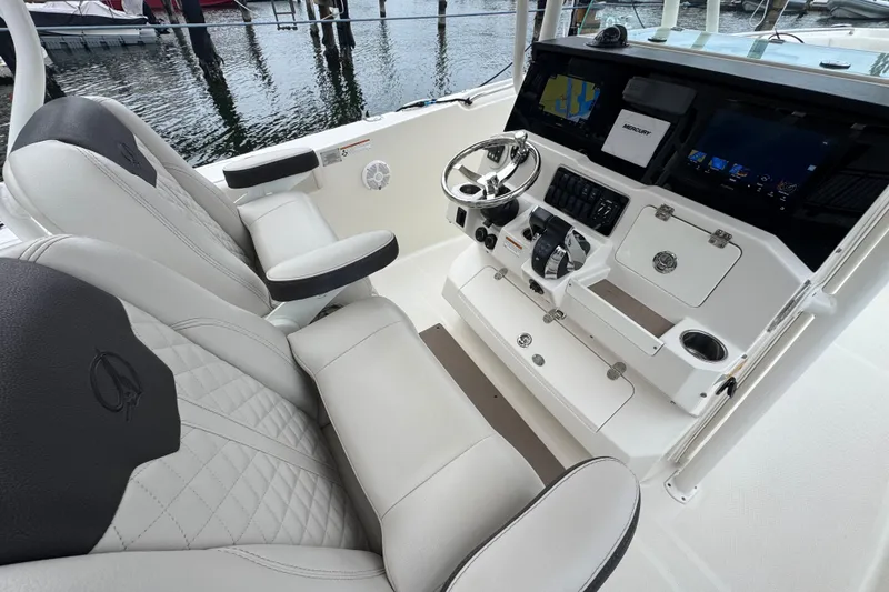 Slide: The Image of 2022 Sailfish 320 CC boat interior with modern helm and dual seating. - 11