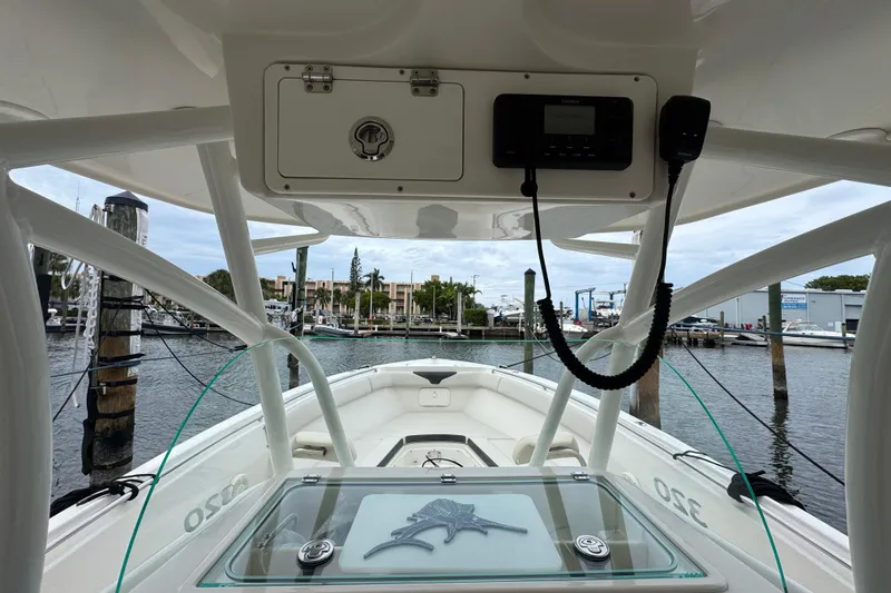Slide: The Image of 2022 Sailfish 320 CC boat interior with console and marina view. - 13