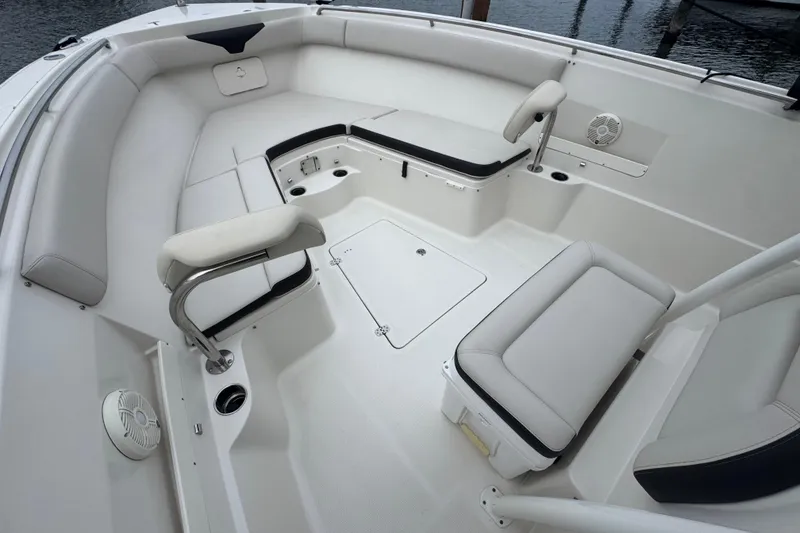 Slide: The Image of 2022 Sailfish 320 CC boat interior with white seating and storage compartments. - 15