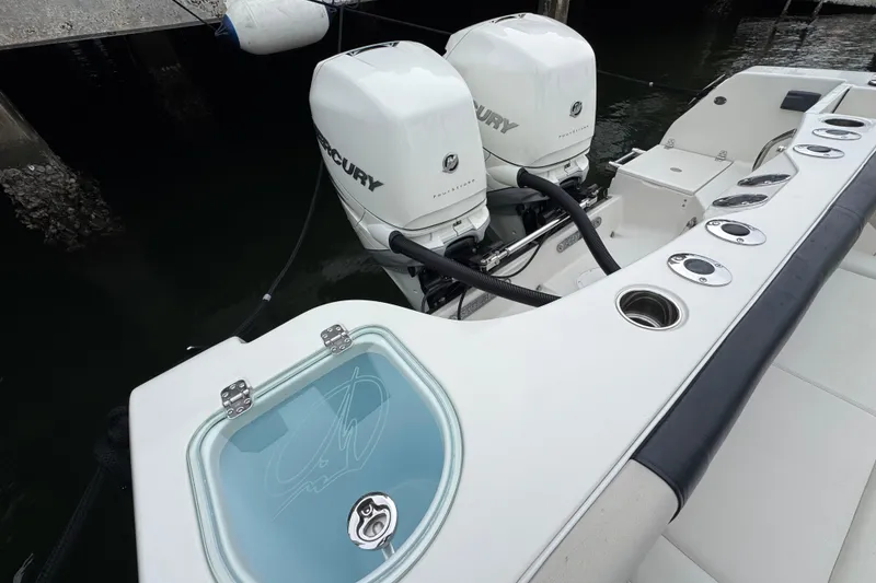 Slide: The Image of 2022 Sailfish 320 CC boat with dual Mercury engines at dockside. - 4