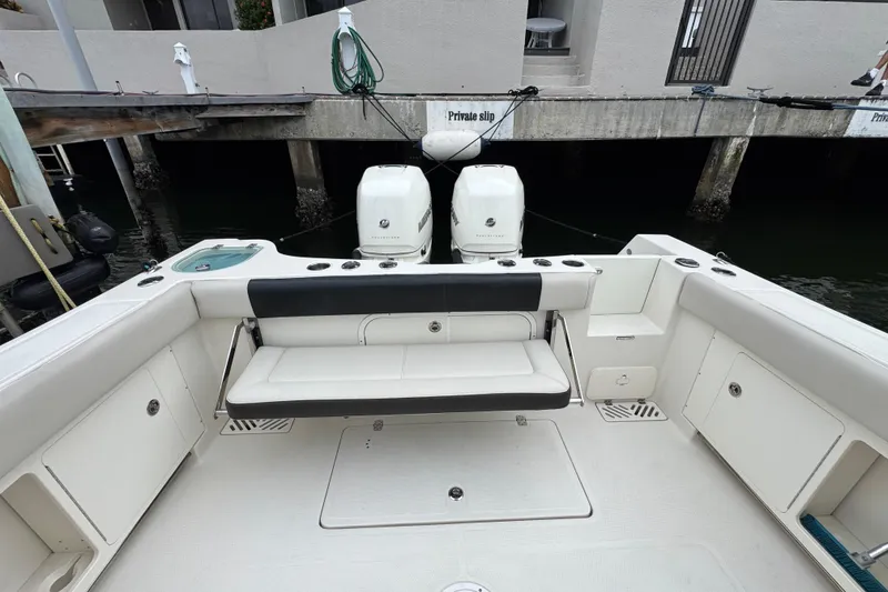 Slide: The Image of 2022 Sailfish 320 CC boat interior with seating and twin outboard engines. - 6