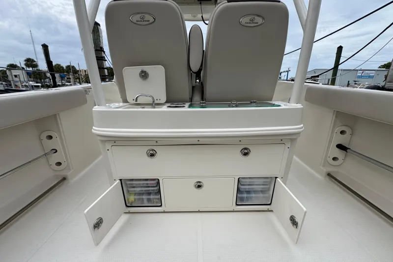 Slide: The Image of 2022 Sailfish 320 CC boat interior with storage compartments open. - 8